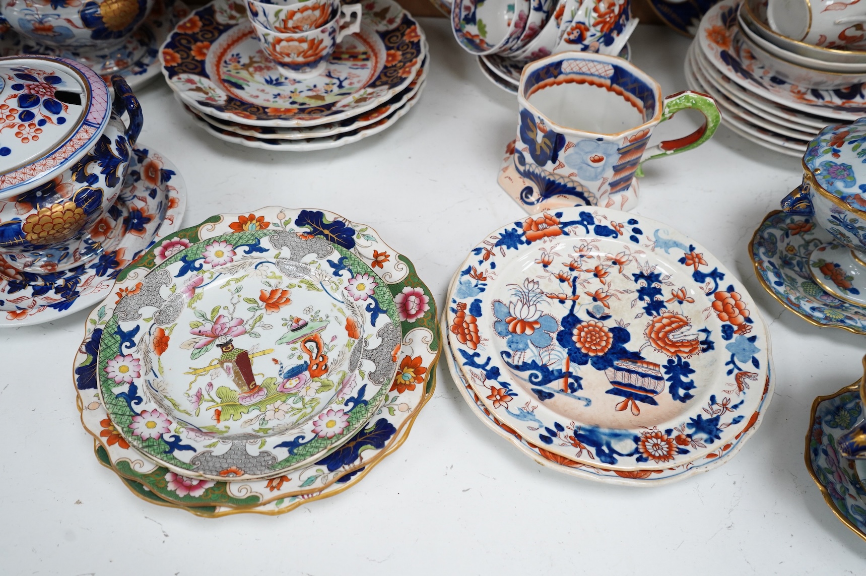 A collection of 19th century English ironstone china to include two pairs of sauce tureens, covers and stands, one marked Masons, various side plates and teacups